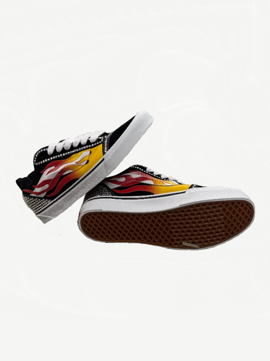 Custom Vans Knu Skool studio view with sparkling rhinestone flame side stripe over black suede sneaker upper