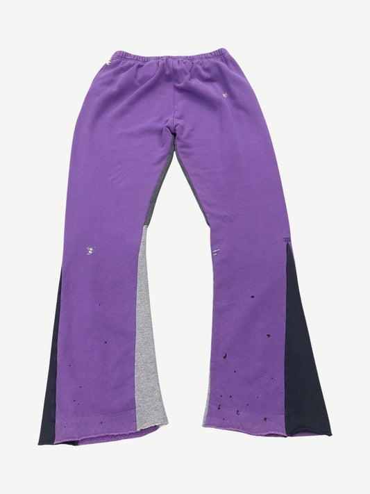 Gallery Dept purple painted flare sweatpants back view, hand-splattered violet streaks across faded grey fleece