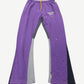 Gallery Dept purple painted flare sweatpants front view, distressed grey base with violet paint splatter streaks
