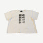 Gallery Hills Brenda's Eyes tee front, cream cotton with stacked black-and-white eye panel print