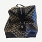 Goyard Boeing 55 duffle bag side profile with brown leather handles and Goyardine chevron print body