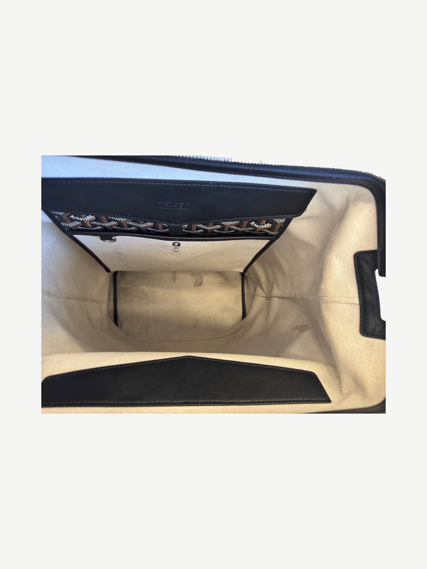 Goyard Cisalpin backpack interior with cream canvas lining and Goyard signed leather inner pocket flap