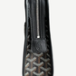 Goyard Jouvence GM toiletry bag opened to reveal lined interior compartment with black Goyardine canvas exterior.