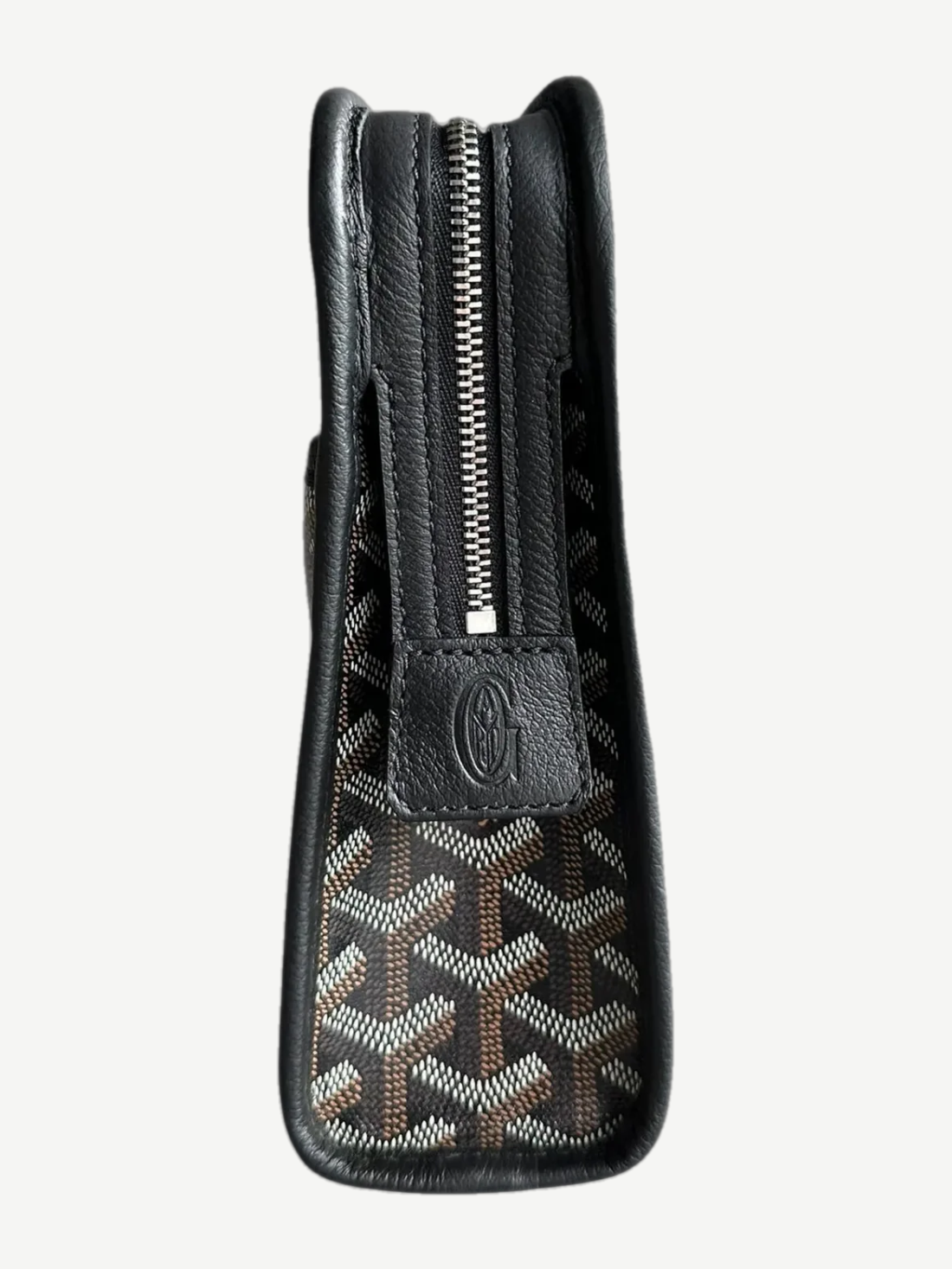 Goyard Jouvence GM toiletry bag opened to reveal lined interior compartment with black Goyardine canvas exterior.