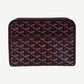 Goyard Jouvence PM toiletry bag in maroon Goyardine canvas with signature chevron print and top zipper.