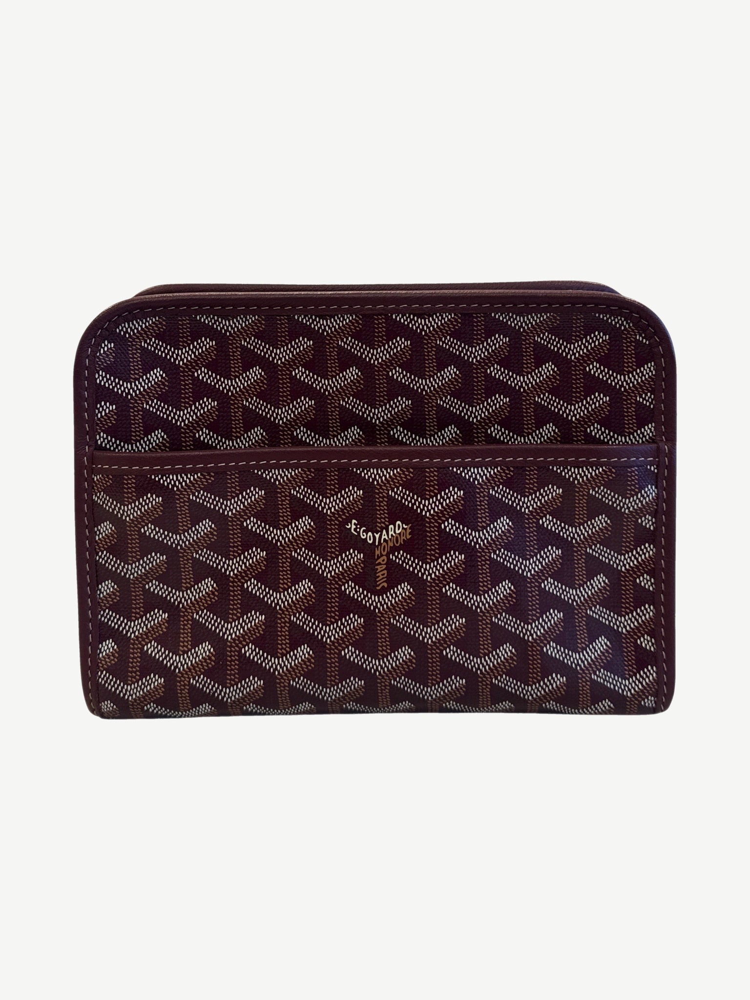 Goyard Jouvence PM toiletry bag in maroon Goyardine canvas with signature chevron print and top zipper.