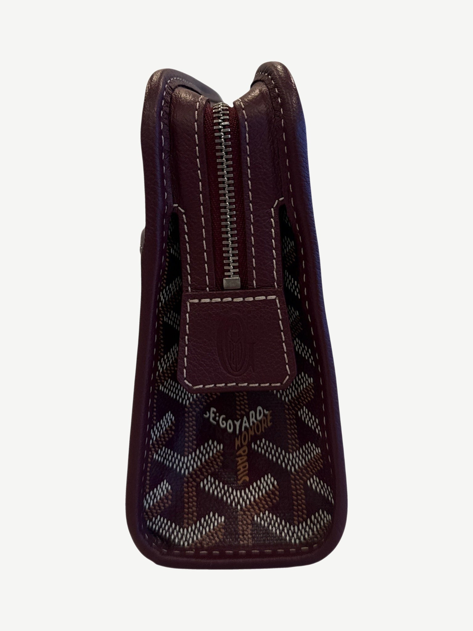 Goyard Jouvence PM toiletry pouch, maroon chevron coated canvas, rectangular silhouette with leather zip pull.