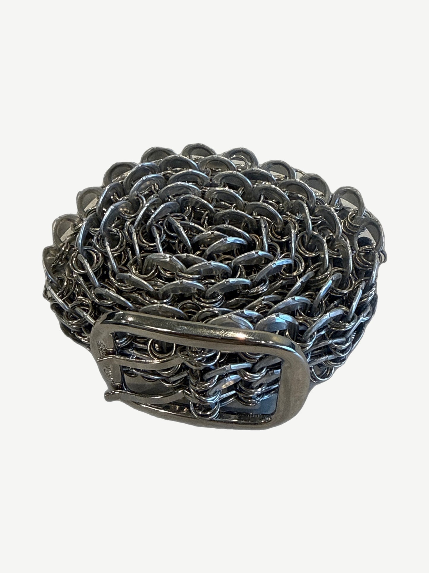 Greedy Unit bottle cap belt coiled showing rosette pattern of interlocking silver bottle cap rings