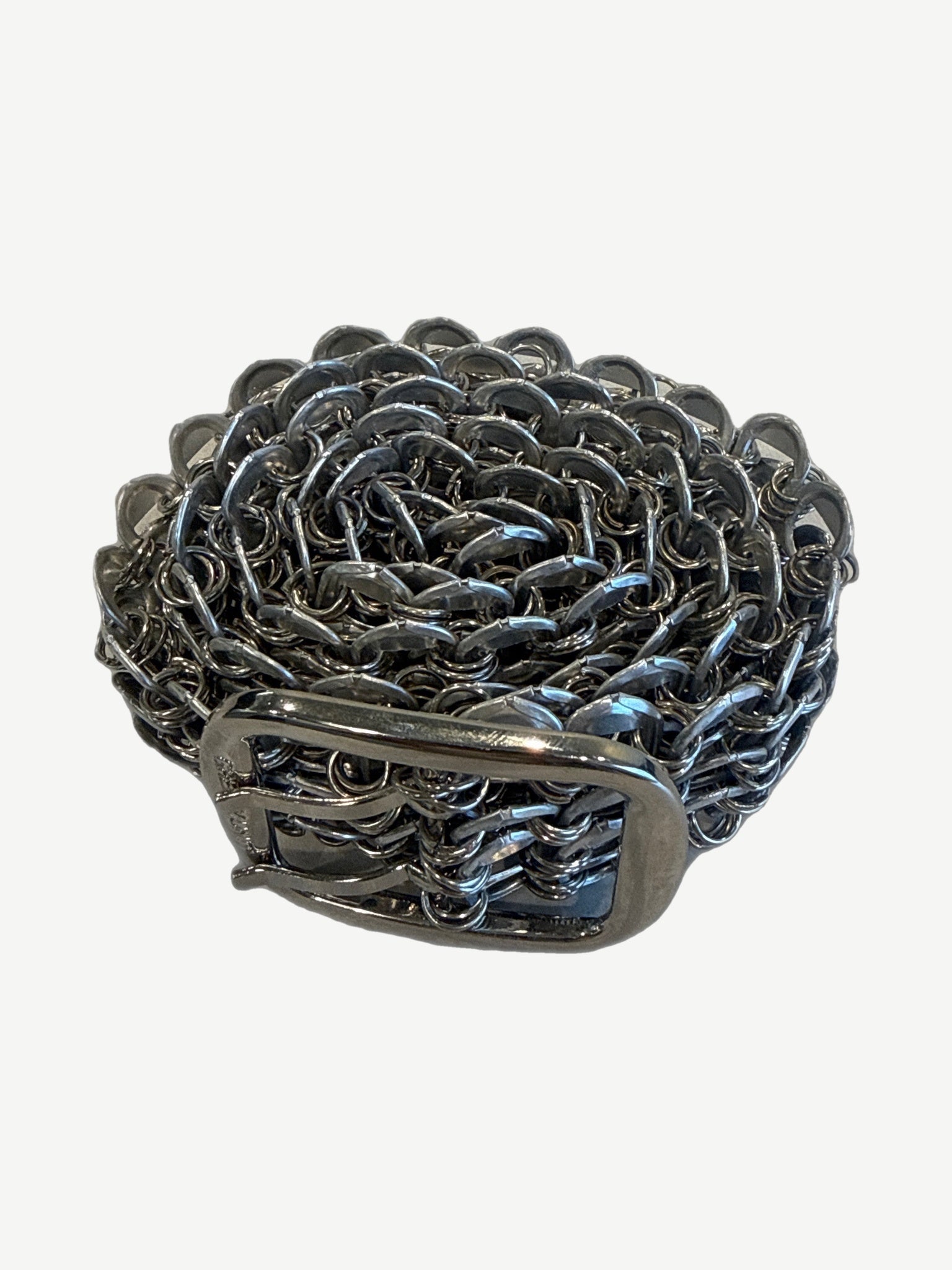 Greedy Unit bottle cap belt coiled showing rosette pattern of interlocking silver bottle cap rings