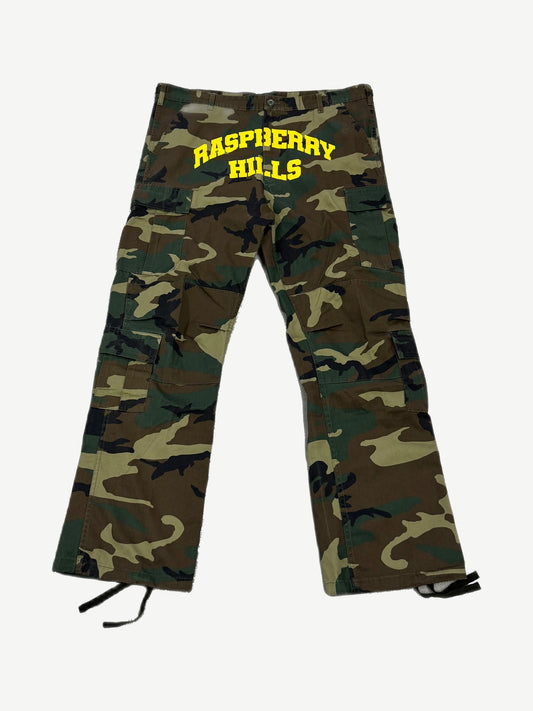 GV Gallery Raspberry Hills woodland camo cargo pants with yellow varsity arch logo print and side pockets