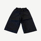 HMDD Juggernaut black nylon shorts back view with elastic waistband and single rear patch pocket.
