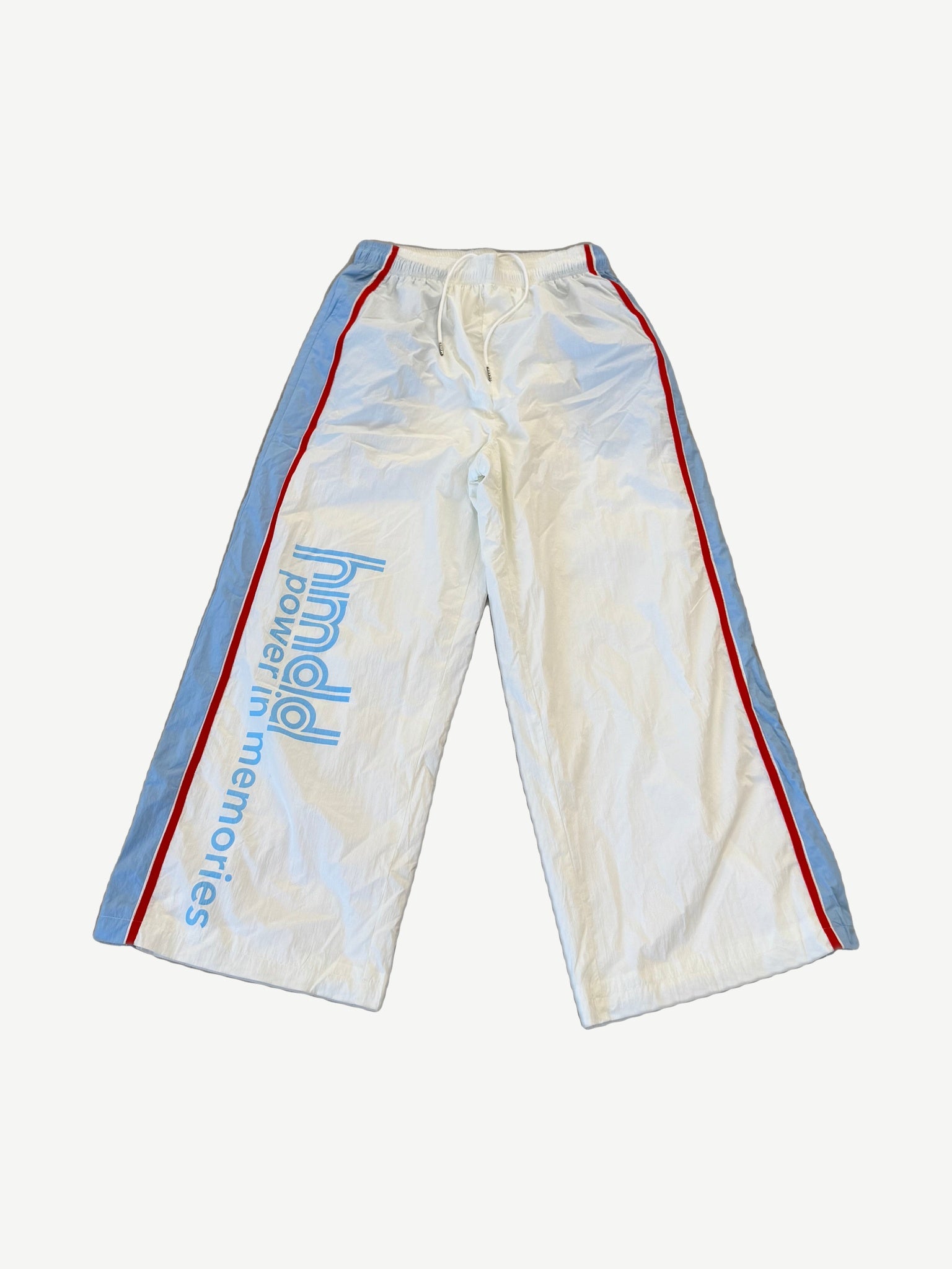 HMDD Luxembourg nylon sweatpants front, white wide-leg track pants with blue side panel piping