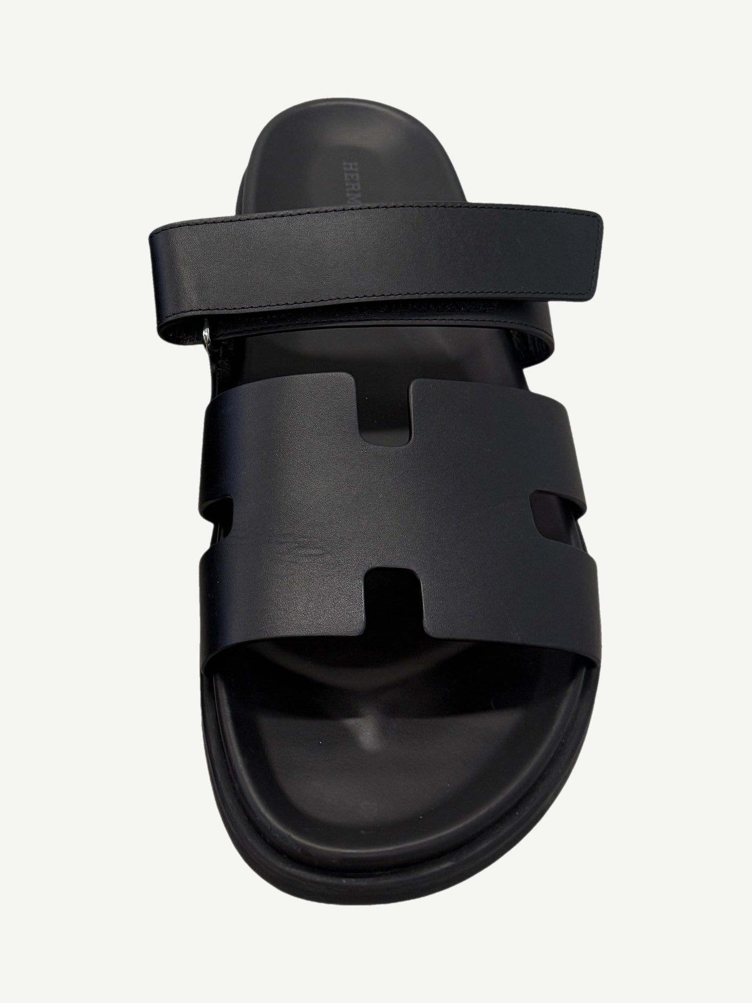 Hermes Chypre sandal single top view with H-cutout vamp strap, adjustable rear strap and molded leather footbed.