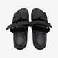 Hermes Chypre sandal pair top-down view, black calfskin straps unfastened revealing Hermes branded leather insoles.