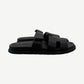 Hermes Chypre sandal in noir black calfskin side profile with adjustable strap and cleated rubber outsole.