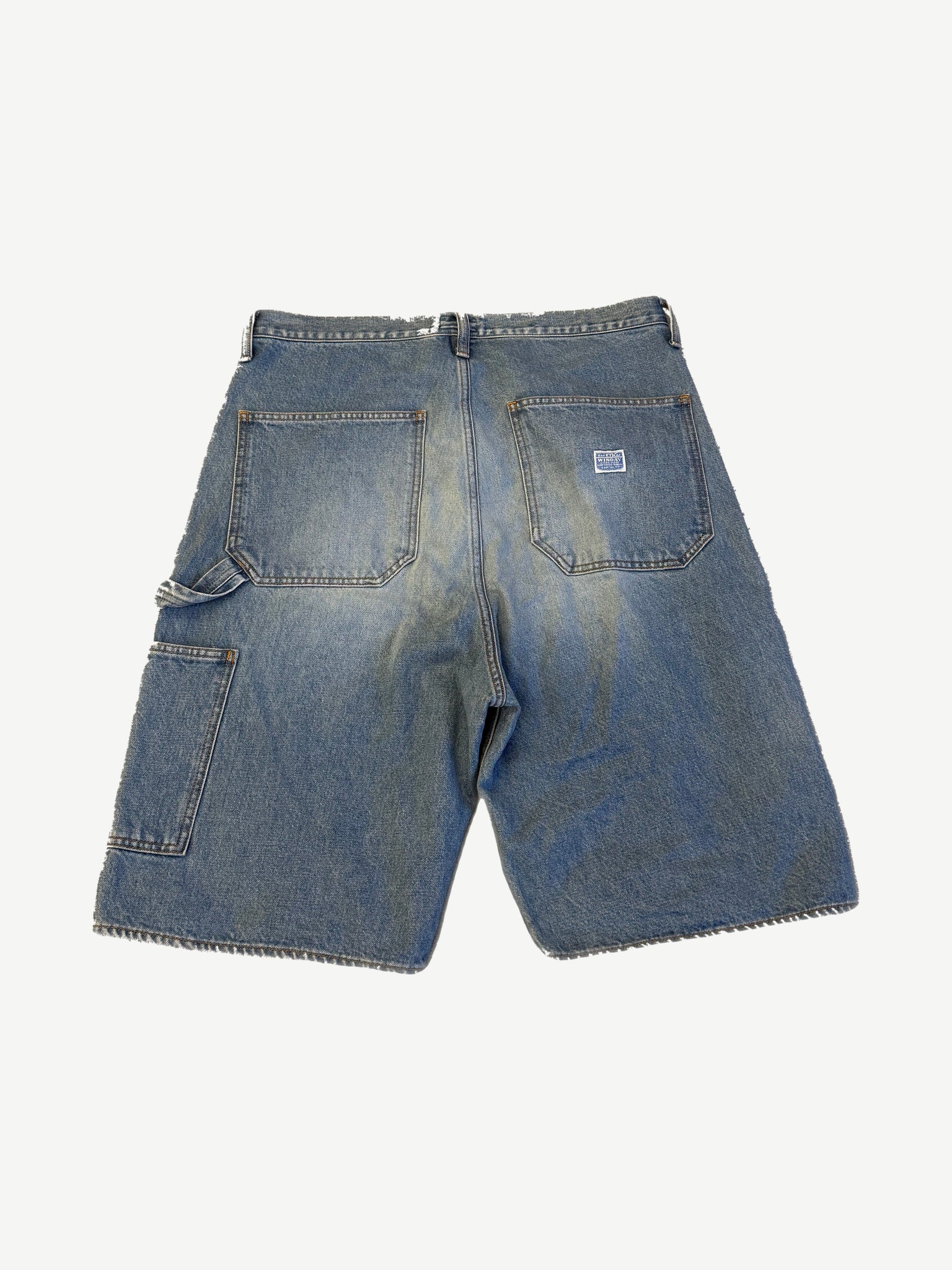 Kapital 14oz indigo denim carpenter shorts back with patch pockets, fades, and white brand label.