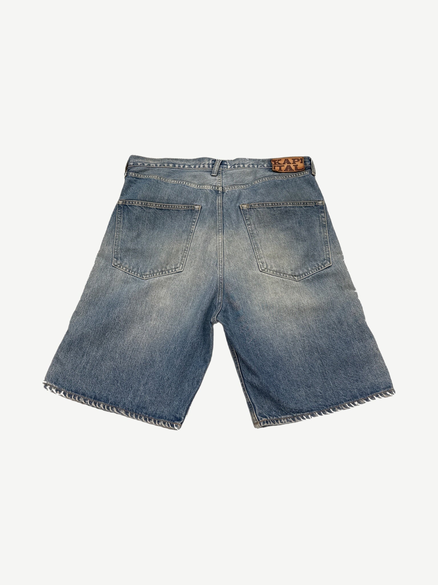 Back of Kapital Cisco denim shorts with leather Kapital patch, twin patch pockets and frayed hem detail