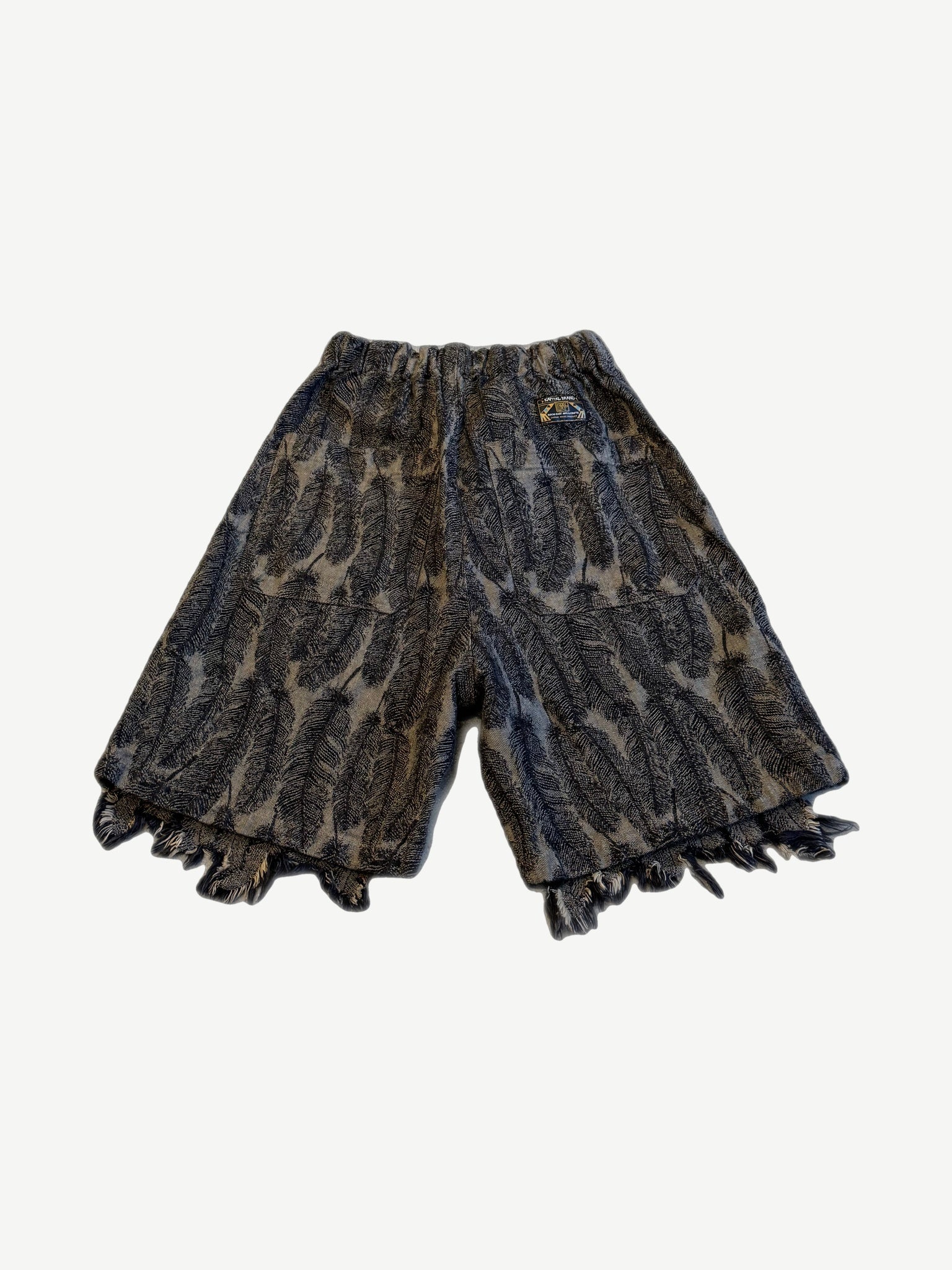 Kapital Magpie denim shorts back view with feather print pattern and wide raw fringed hem detail.