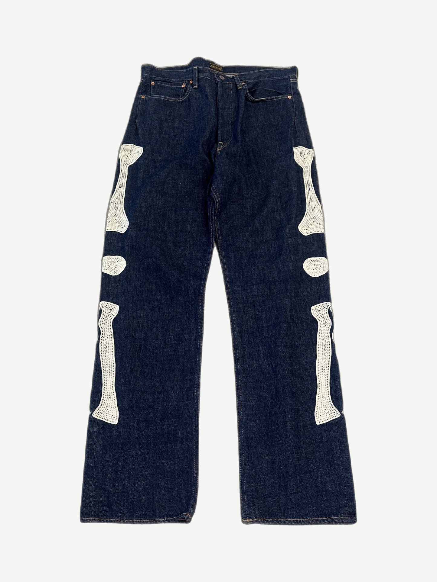 Kapital raw indigo bone denim jeans front with skeletal bone embroidery down leg and five-pocket cut.
