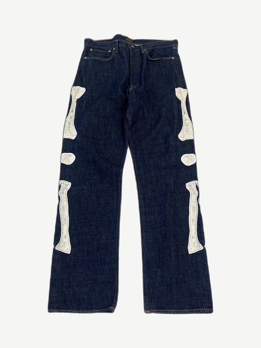 Kapital raw indigo bone denim jeans front with skeletal bone embroidery down leg and five-pocket cut.