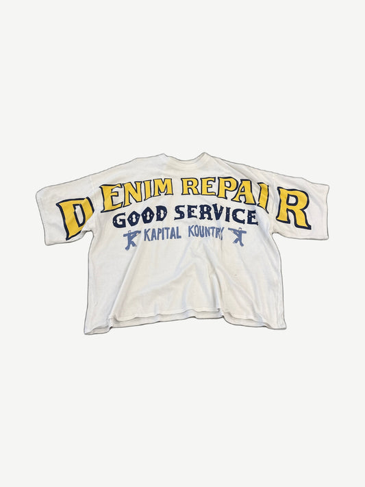 Kapital white oversized tee with yellow DENIM REPAIR arched text and Kapital Kountry good service print