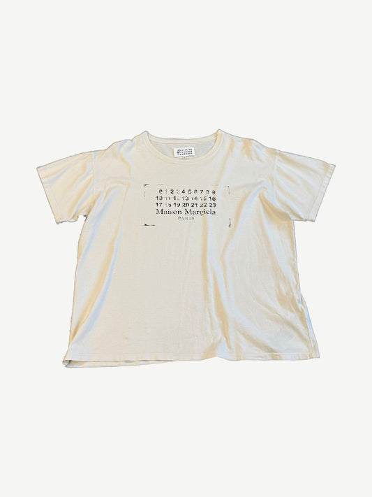 Maison Margiela stamp logo tee in cream with stenciled numerical calendar and Paris logo chest print