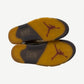 Off-White Jordan 5 Sail outsoles showing translucent yellow Jumpman traction pattern with Nike branding