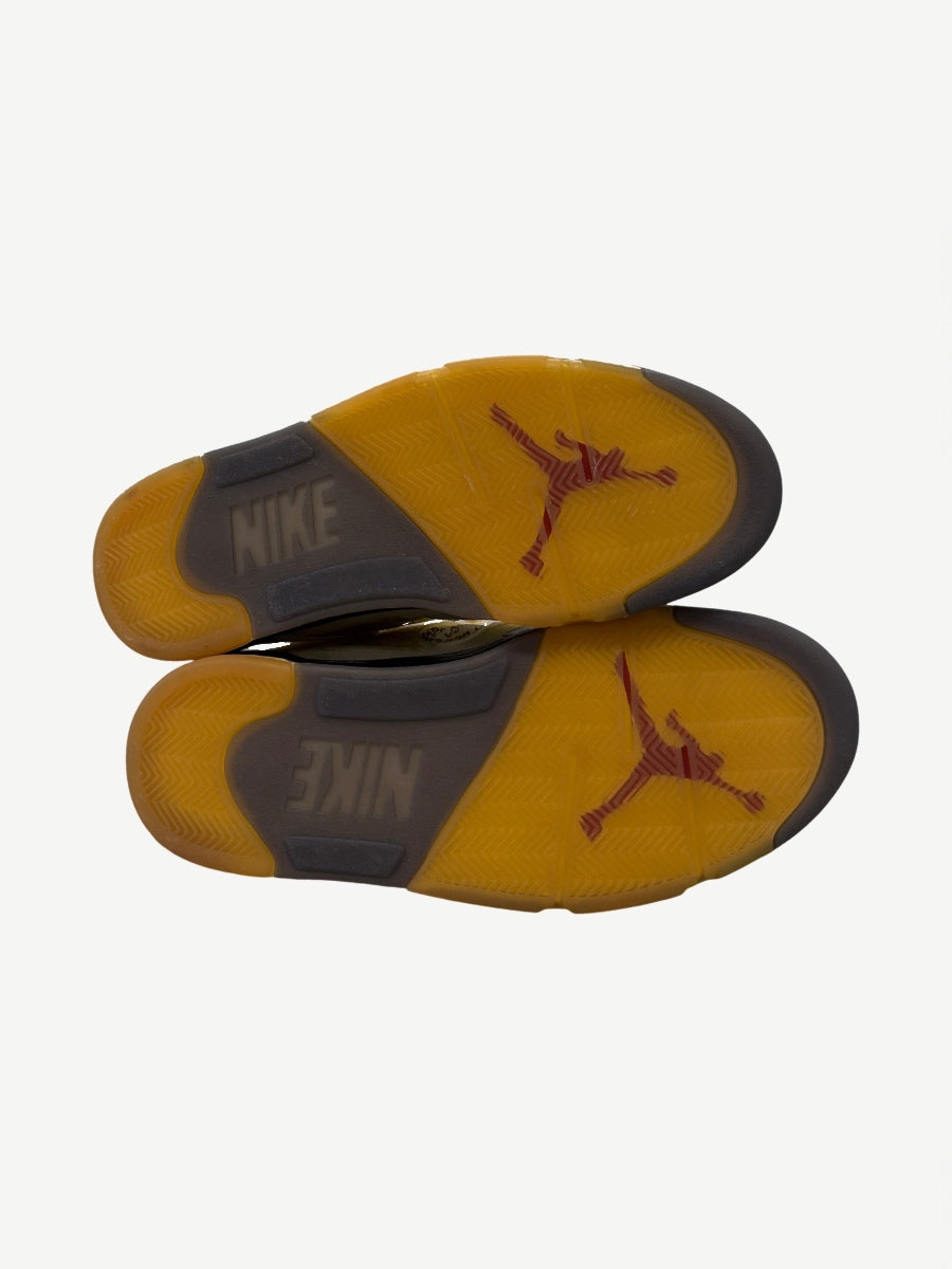 Off-White Jordan 5 Sail outsoles showing translucent yellow Jumpman traction pattern with Nike branding