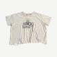 Paly Hollywood Arigo tee front view in distressed white cotton with vintage graphic print and worn hem