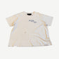 Paly Hollywood Elvis Mon Amor cream distressed tee with blue chest scribble text and pinholes, front view