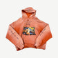 Paly Hollywood faded orange hoodie front with photo print graphic and curved sleeve text.