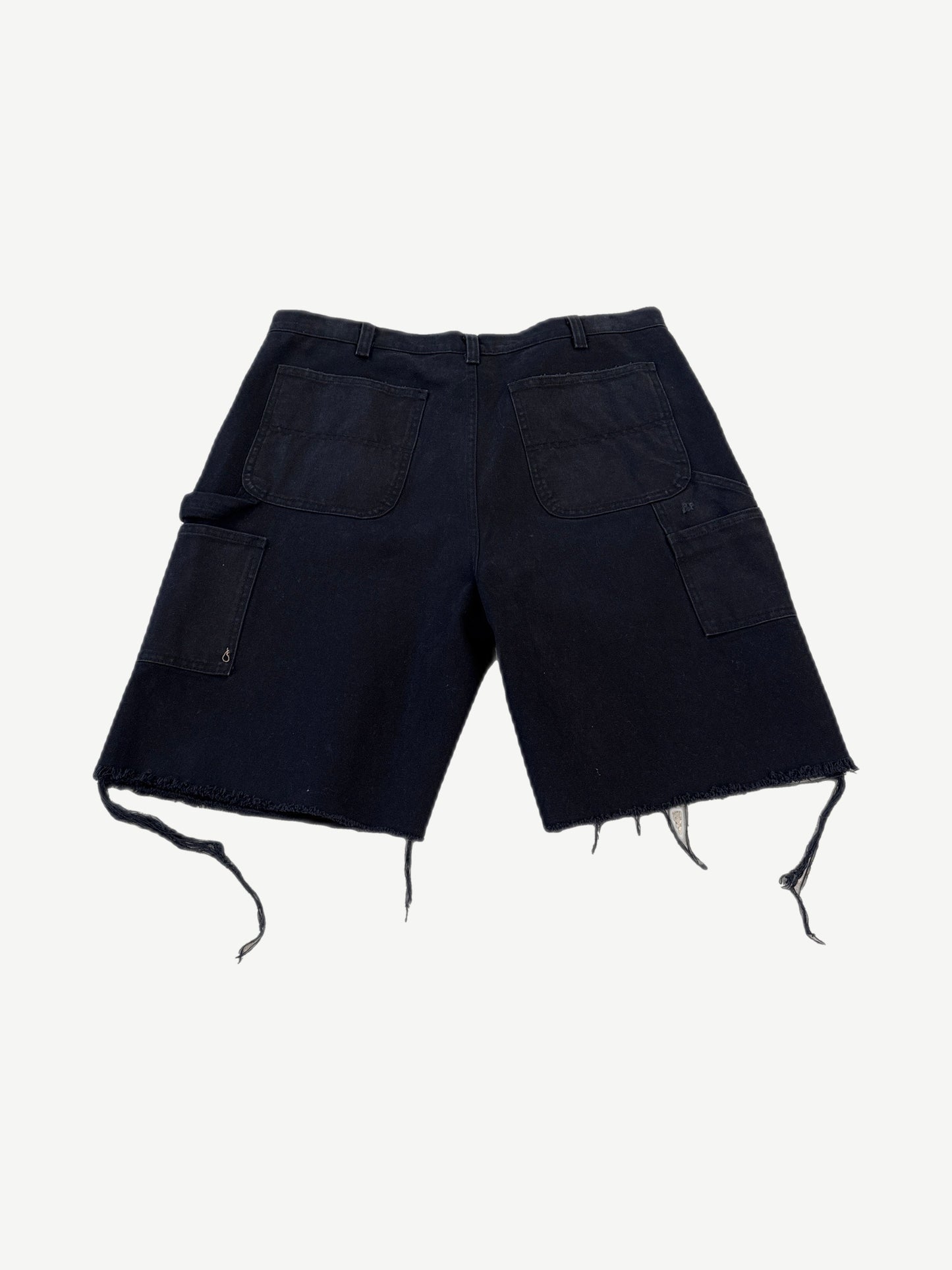 Back of Paly Hollywood F1 black carpenter shorts with utility pockets, hammer loop and distressed frayed cuffs