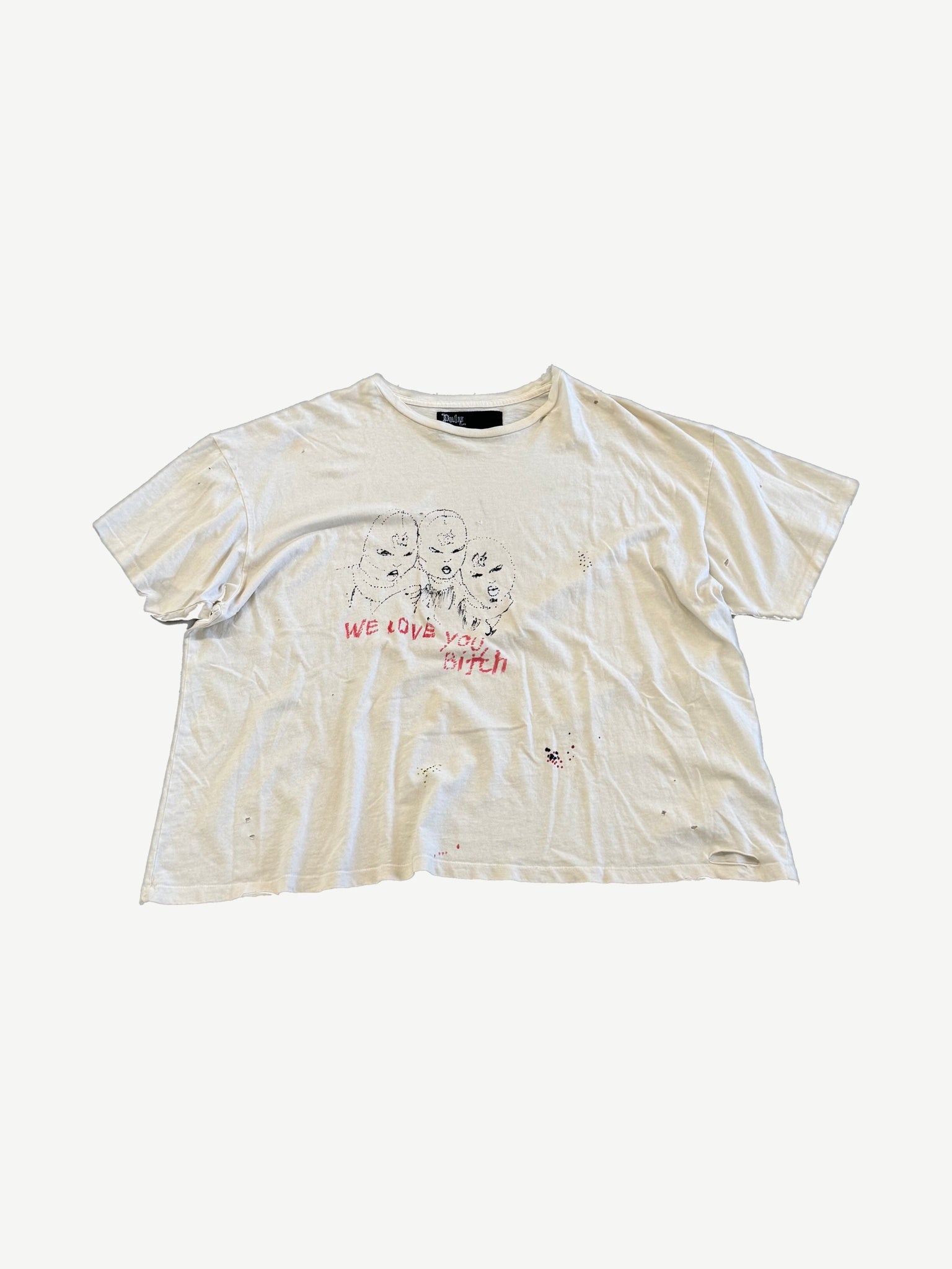 Paly Hollywood cream tee with We Love You Bitch hand-drawn faces print and paint splatter