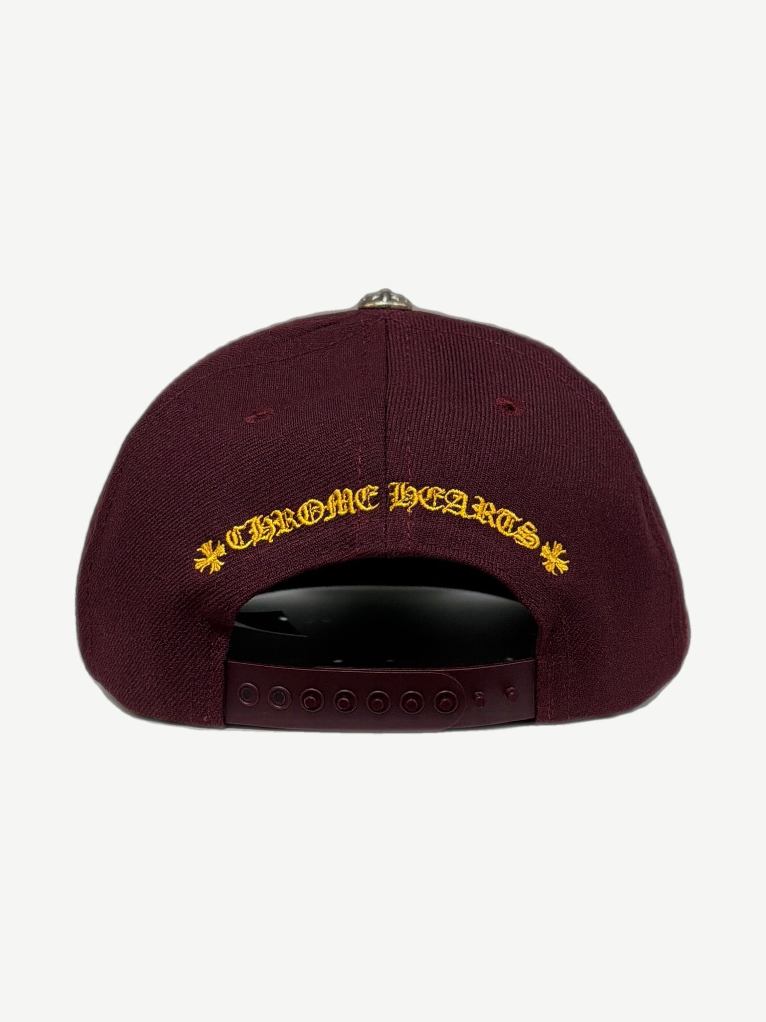 Chrome Hearts burgundy cap back with yellow Chrome Hearts script and cross flowers, snapback closure.