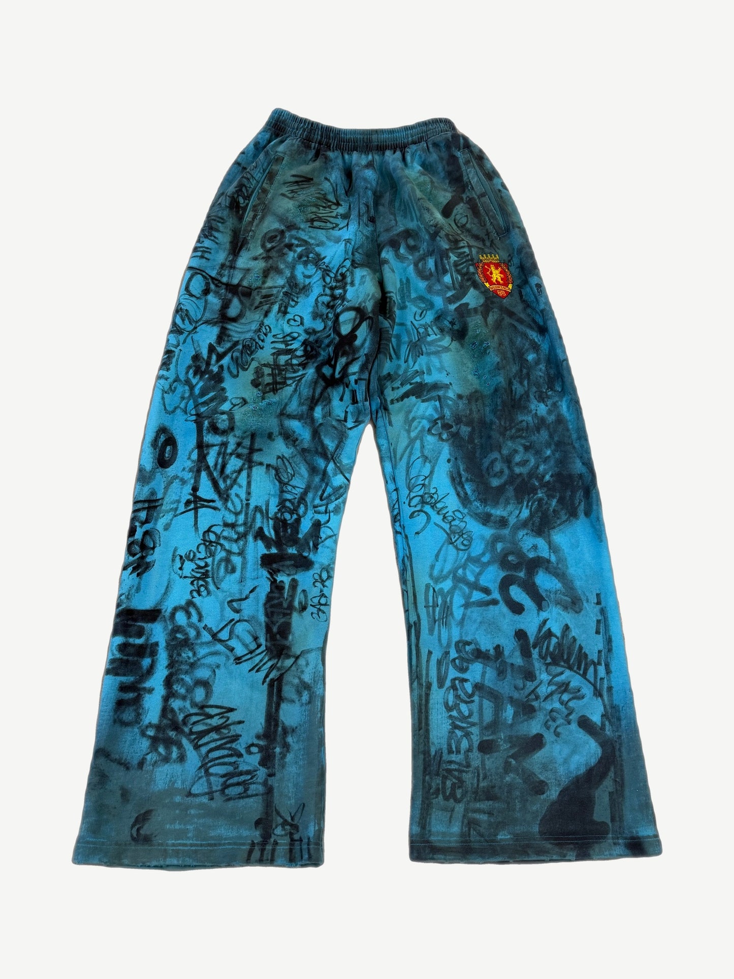 Balenciaga blue skater baggy sweatpants with allover hand-scrawled graffiti print and drawstring waist.