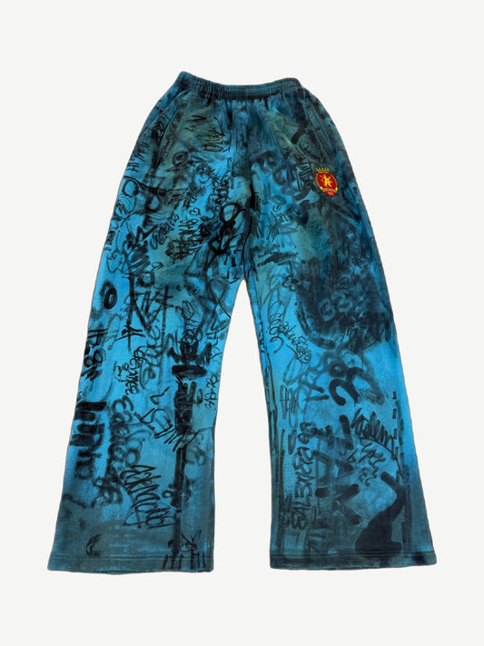 Balenciaga blue skater baggy sweatpants with allover hand-scrawled graffiti print and drawstring waist.