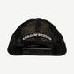 Back of Chrome Hearts black mesh trucker hat with gothic logo strap patch and adjustable snapback.