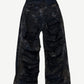 Back of Balenciaga mud wash destroyed jeans showing ripped pocket detailing and oversized straight leg silhouette.