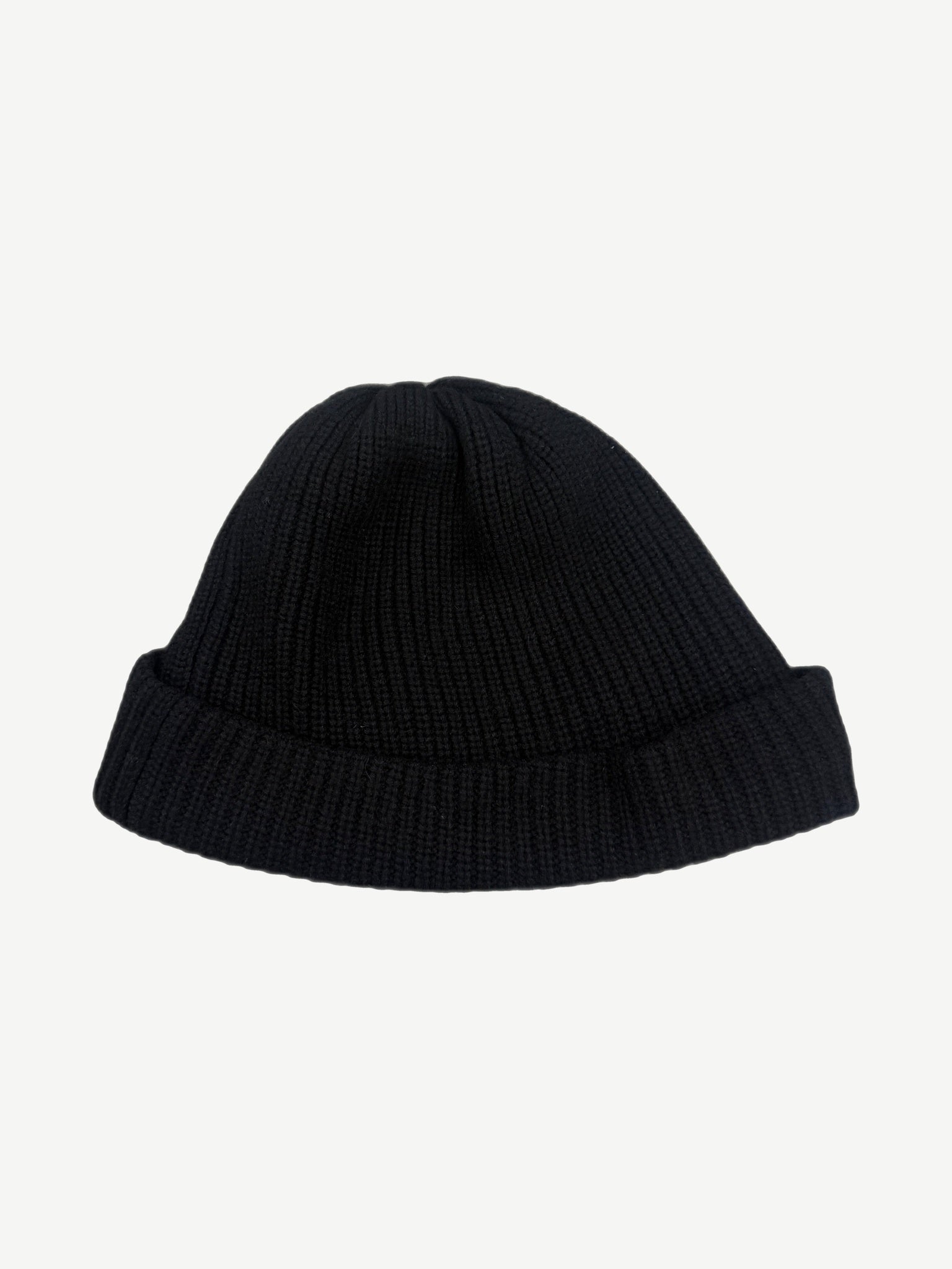 Chrome Hearts black cashmere knit beanie back, plain ribbed cuffed silhouette without graphics.