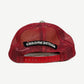 Chrome Hearts red trucker hat back view with black Chrome Hearts gothic scroll patch on red mesh and snapback closure.