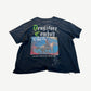 Paly Hollywood UDLI tee back, faded black cotton with scattered distress, painterly scribble text print