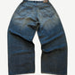 Balenciaga waxed blue baggy jeans alternate view showing slick wax-coated denim and oversized fit.