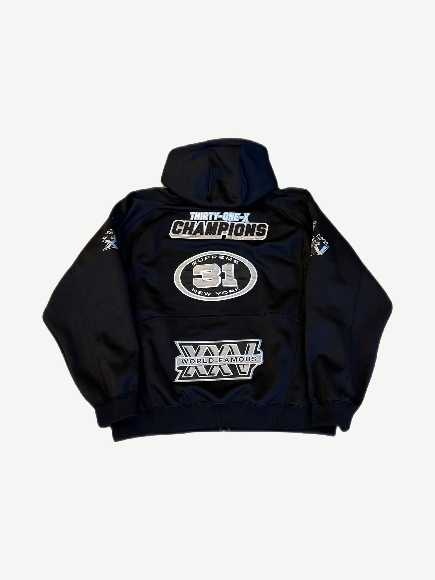 Supreme black football zip hoodie back view with Champions and World Famous racing patches.