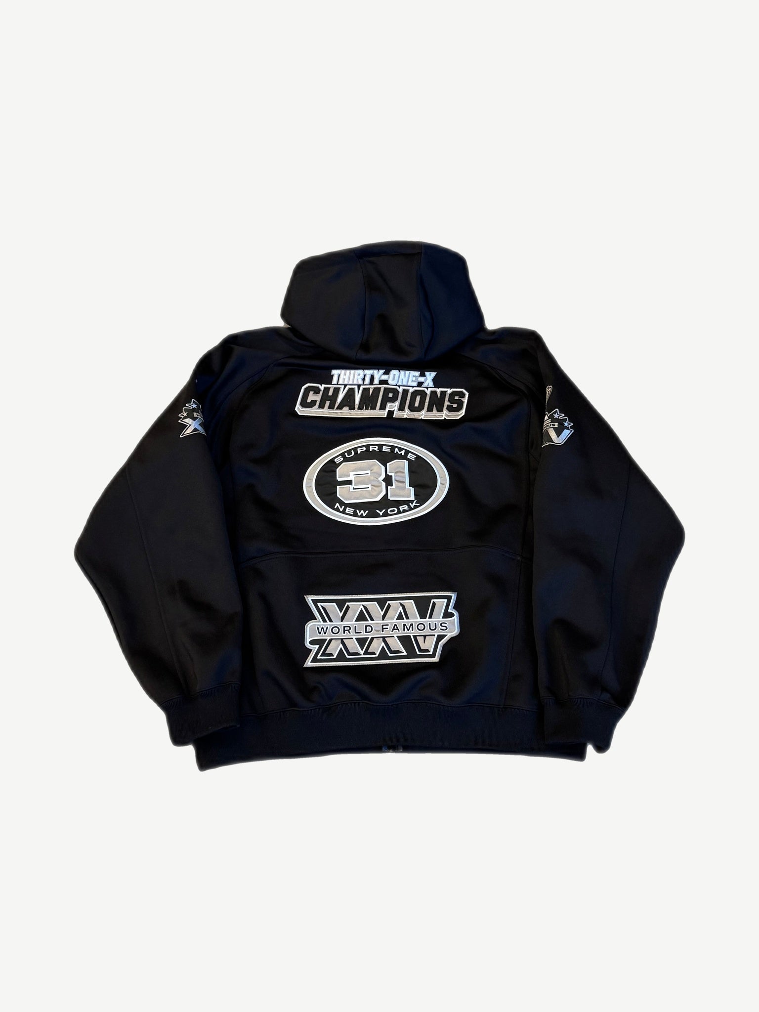 Supreme black football zip hoodie back view with Champions and World Famous racing patches.