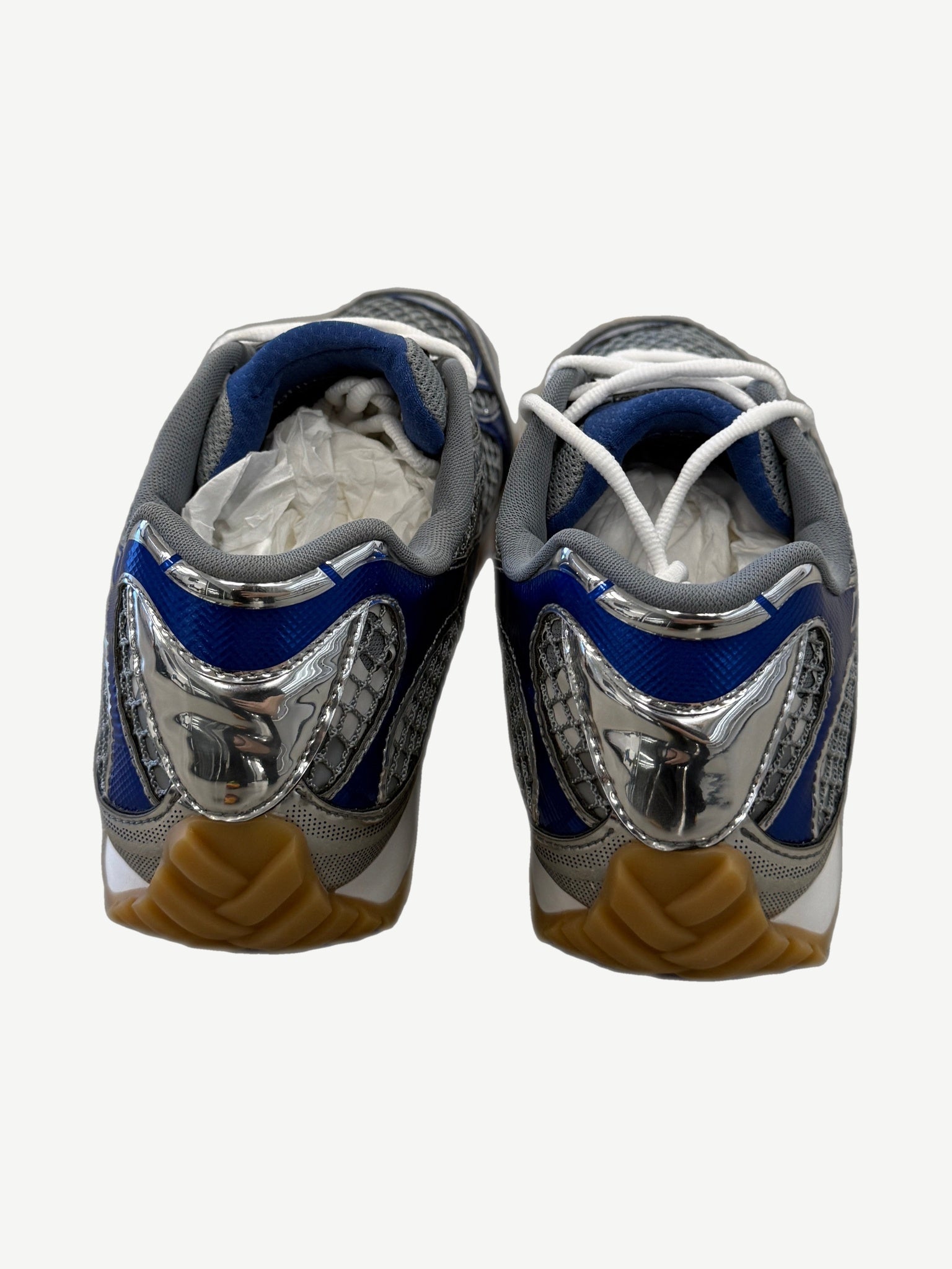Bottega Veneta Orbit sneakers rear view showing mirrored silver heel cups and royal blue accent panels
