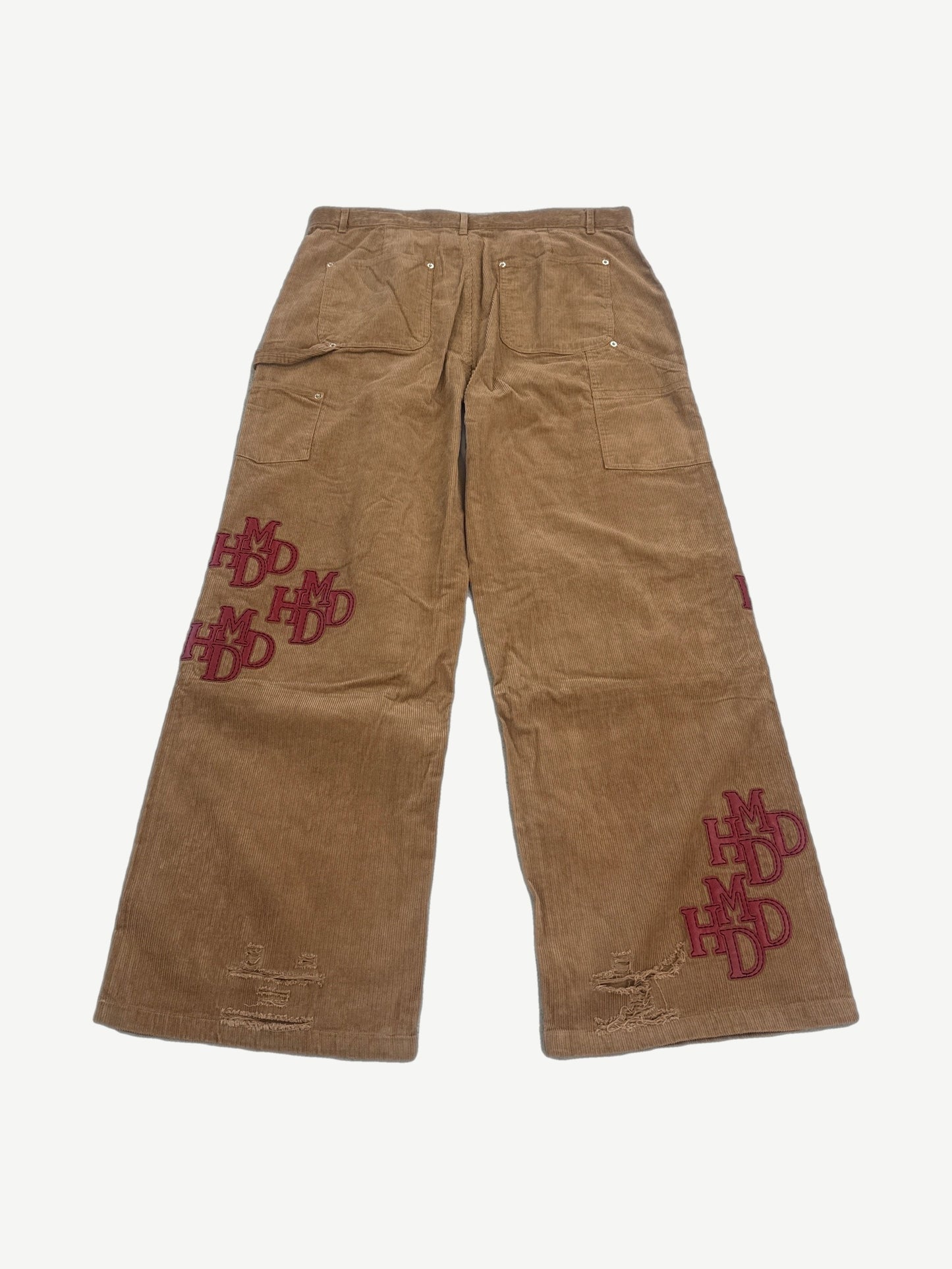 Happy Memories Don't Die HMDD tan corduroy pants back with stacked red HMDD logo patches on both legs