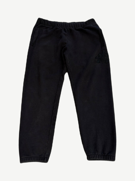 Chrome Hearts black Paper Jam sweatpants with cluster of black leather cross patches on right thigh