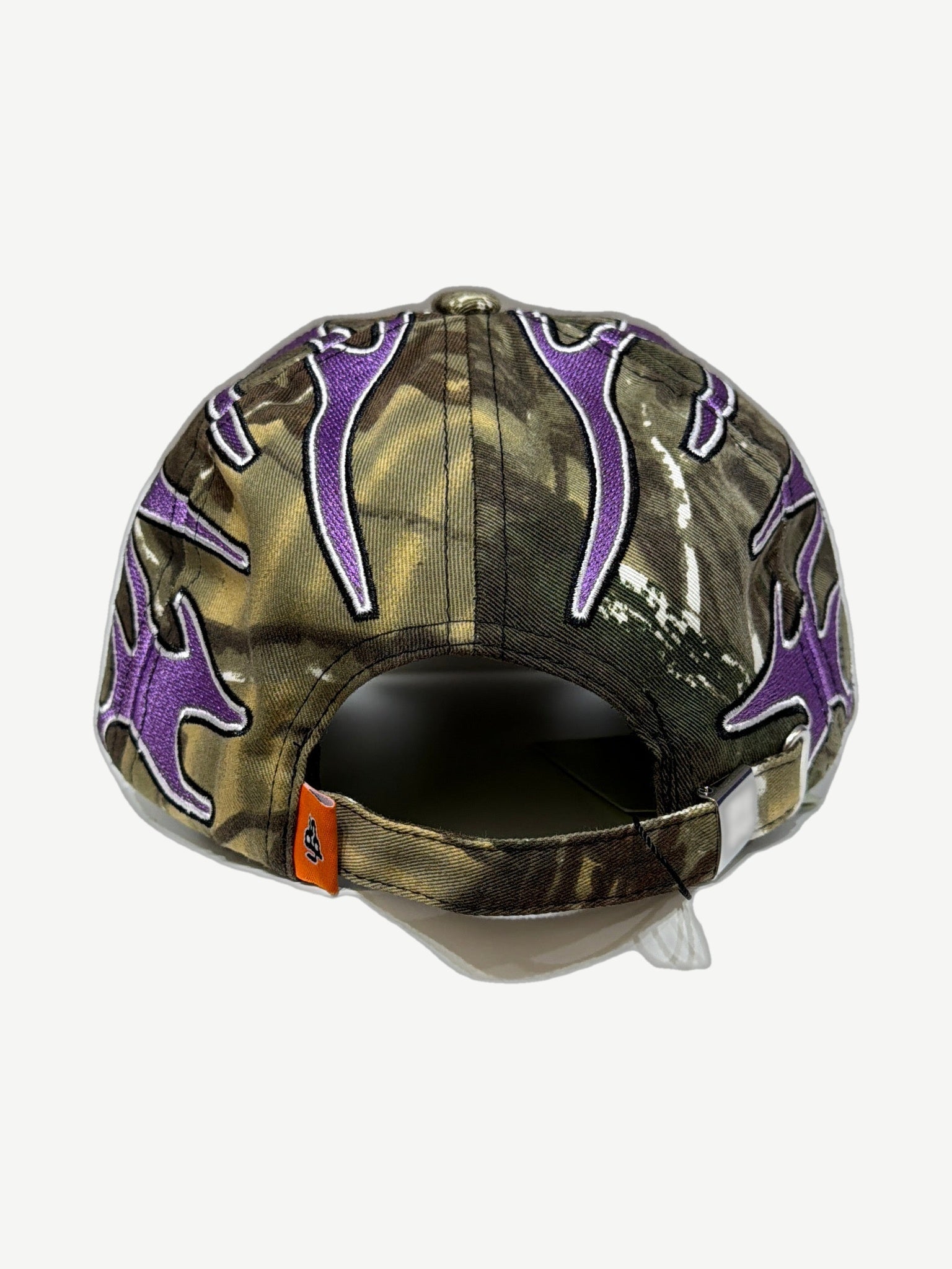 Living Product camo cap rear view with purple flame embroidery and adjustable strap closure