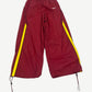 HMDD maroon nylon trackpants front view with gold side stripes and small white logo at hip