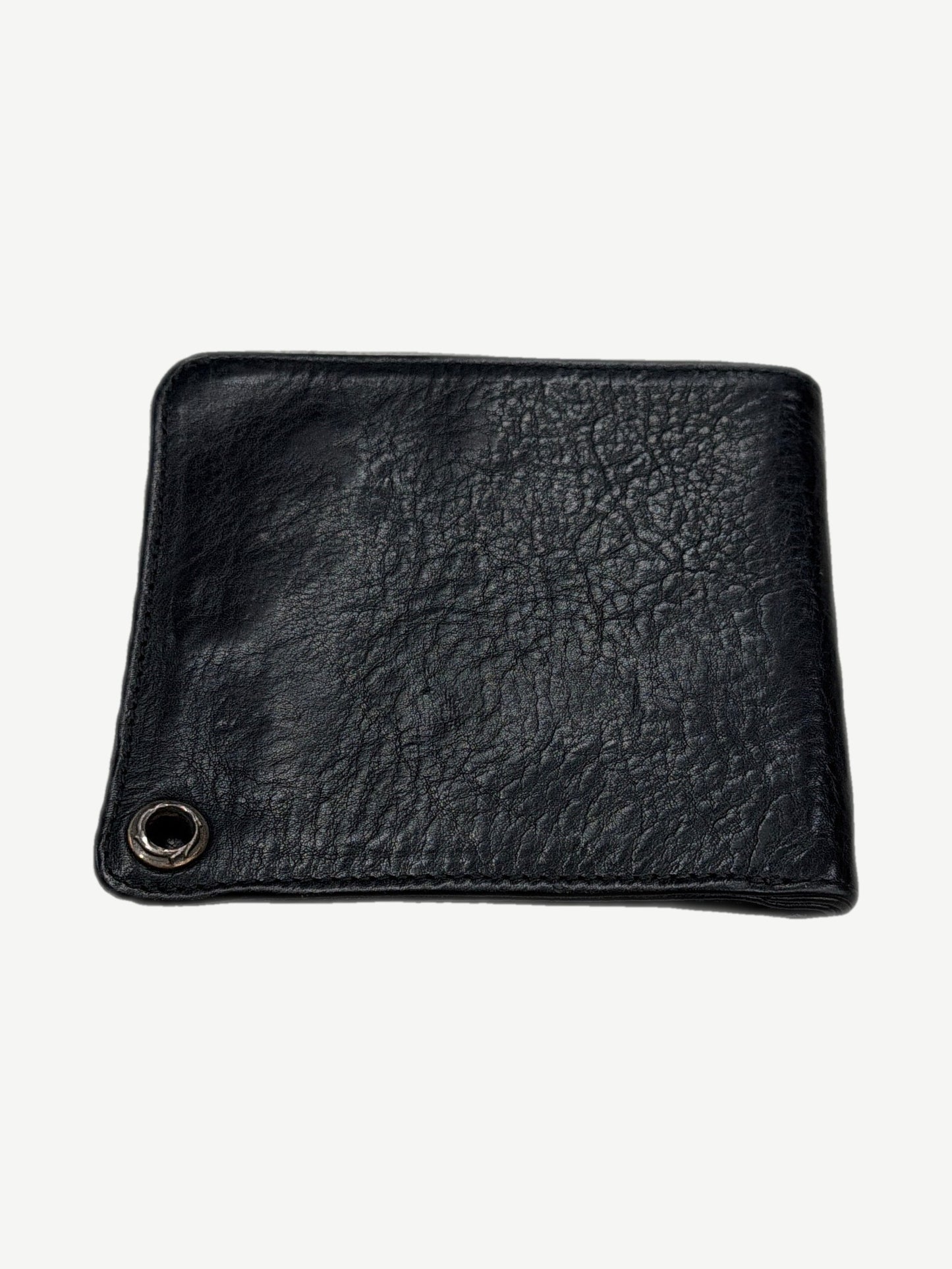 Chrome Hearts black leather bifold wallet back view with silver chain grommet and creased grain texture
